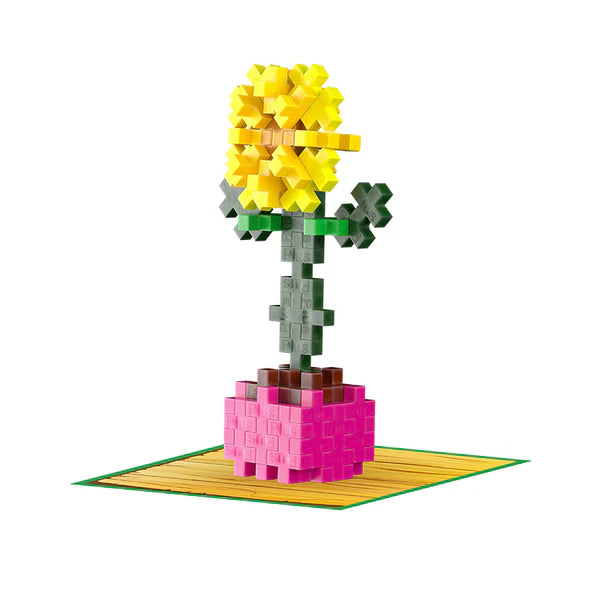Plus Plus Playful Plant Packet featuring a yellow sunflower build on a pink base with green leaves and themed mat.