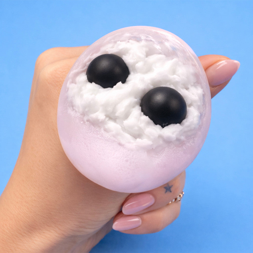 The Pits Grumpy Fruits squishy toy with a grumpy fruit face held in hand