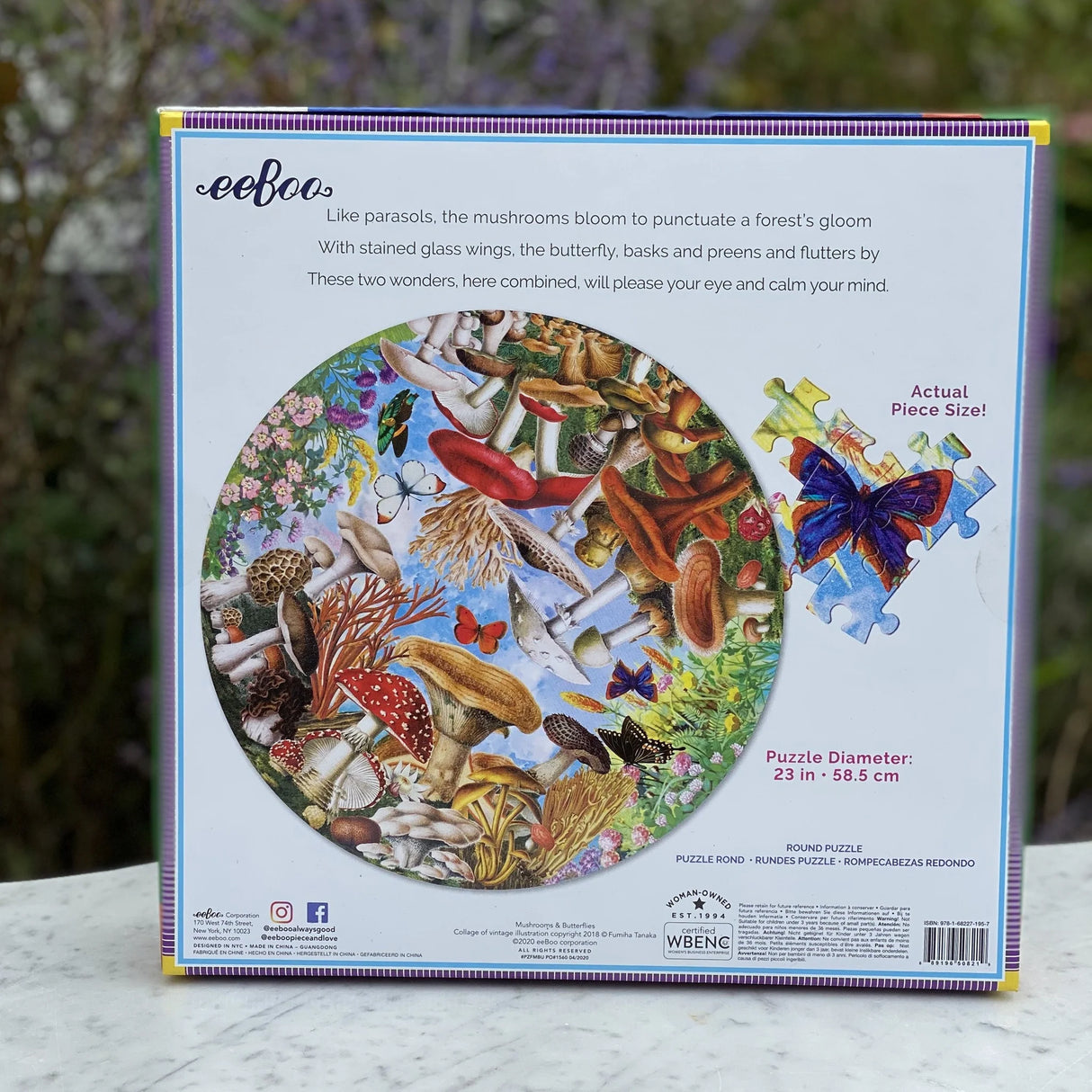 500pc Mushrooms & Butterflies Round Puzzle featuring a colorful collage of mushrooms and butterflies in a whimsical garden.
