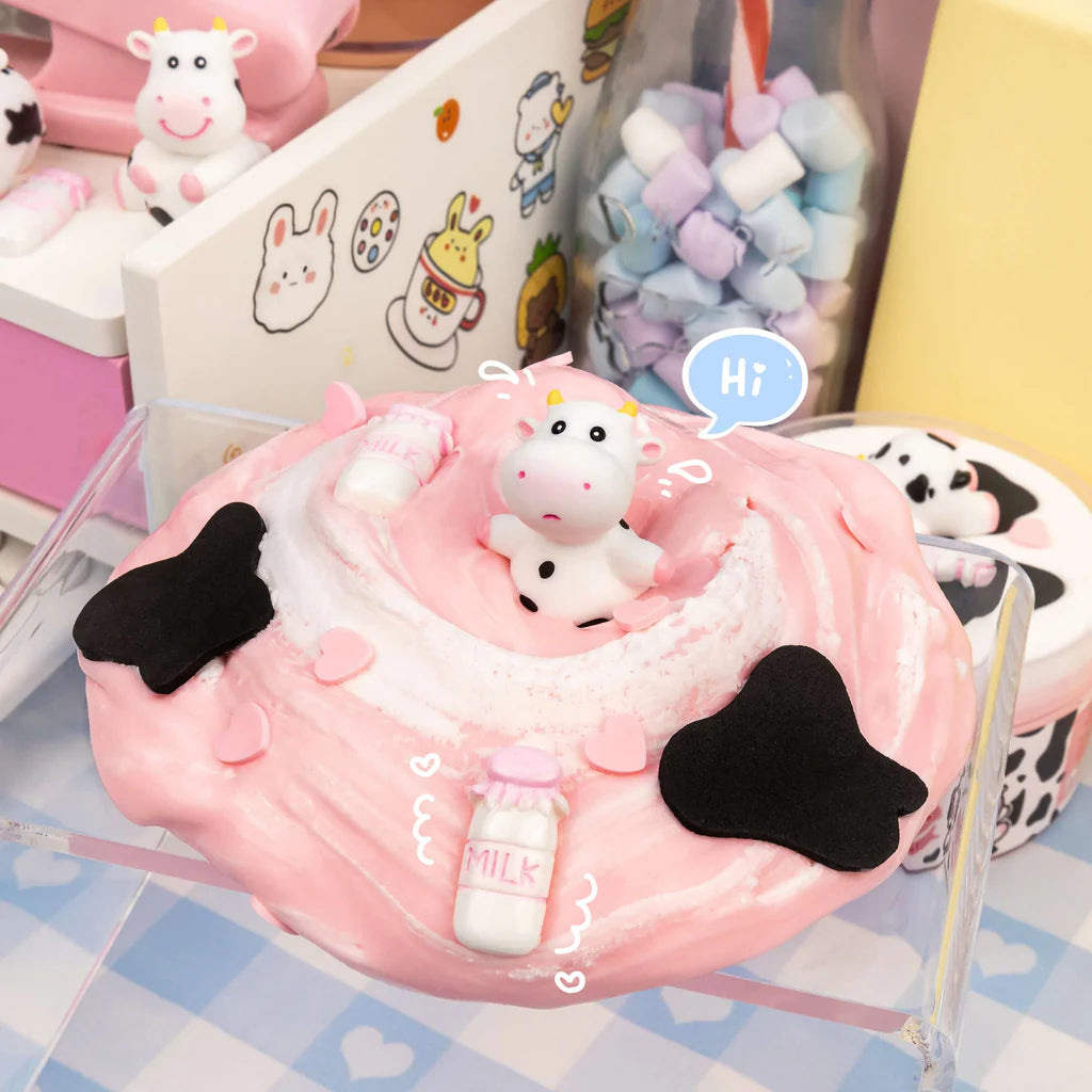 Straw-Dairy Cow 2 Slimes in 1 with pink swirl, clay cow topper, milk bottles, and cow print accents.