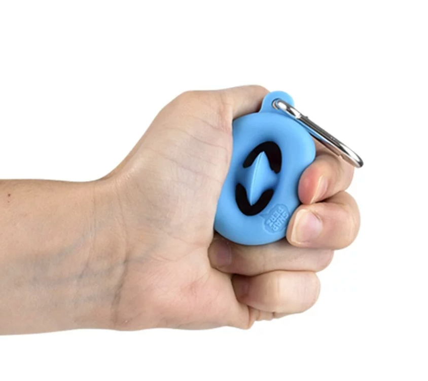 Hand holding a blue Mini Snapperz Keychain being squeezed, demonstrating its fidget and stress relief function.