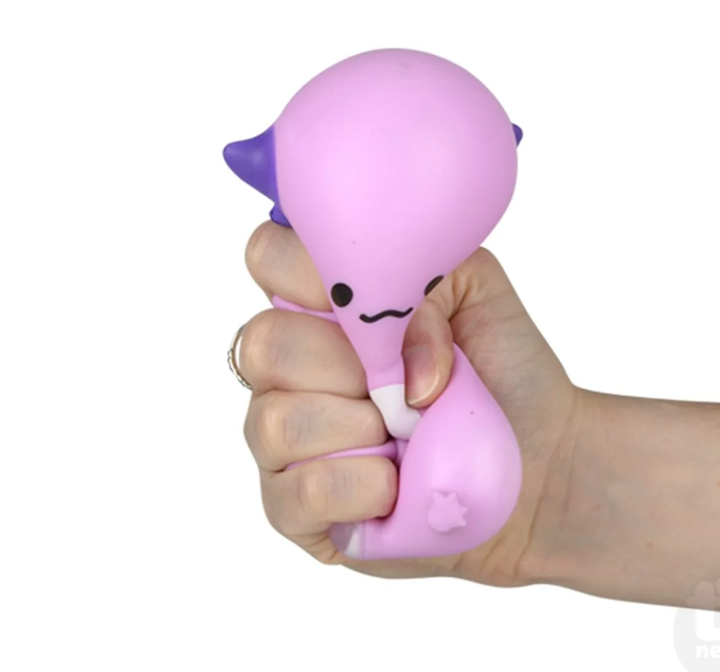 Hand squeezing a pink Squish & Stretch Axolotl fidget toy, perfect for stress relief and sensory play.