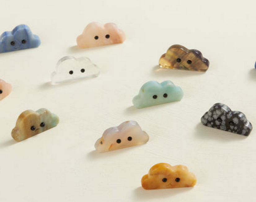 Crystal Cloud Friend assorted polished crystals shaped like clouds with black obsidian eyes and a small mouth, 2 inches wide.