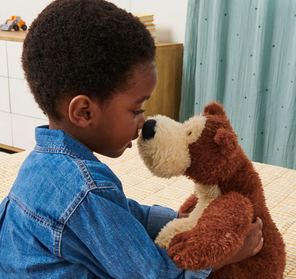 Child cuddling an 11-inch plush Teddy Bear Goober with two-tone chocolate and vanilla soft fur.
