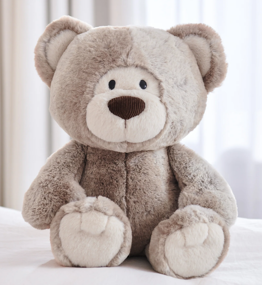 Teddy Bear Mukki plush toy with woodgrain two-tone fur, dark brown nose, cream paws, and oversized mitten-shaped paws.
