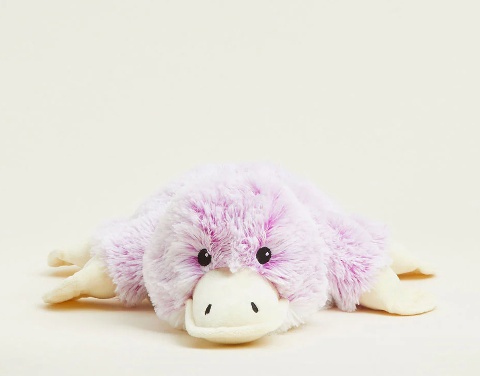 Warmies Plush Platypus lying down, furry lavender-scented microwavable plush for soothing warmth and comfort.