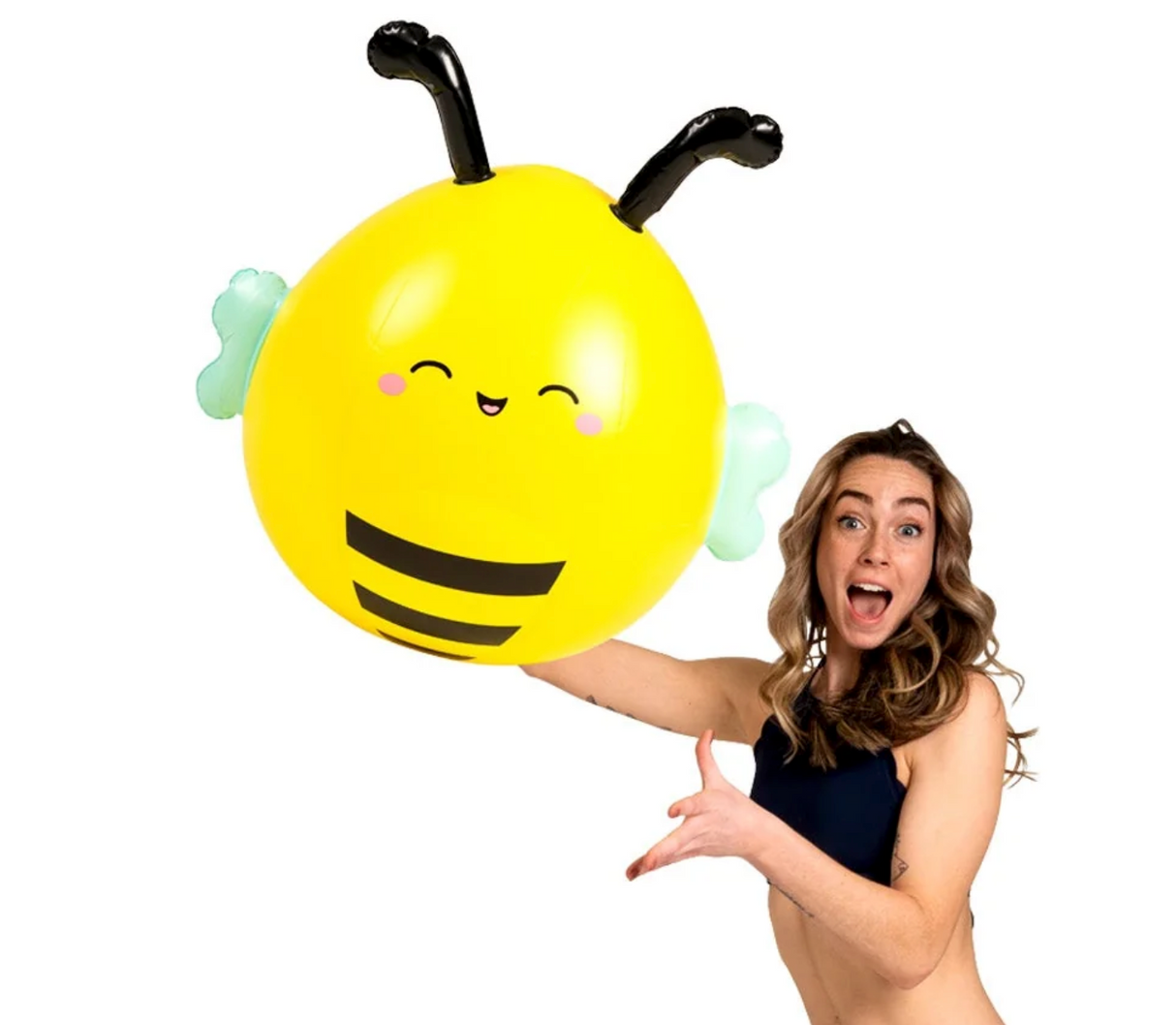 Woman holding a bright yellow Beach Ball | Squishmallow Sunny the Bee with smiling face and black antennae.