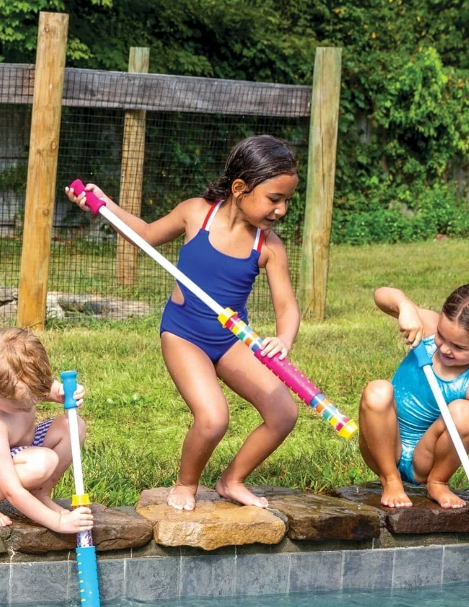 Child playing with a Magenta Water Cannon by the pool, holding a foam handle for super soaking fun.