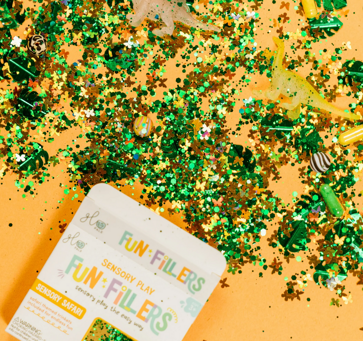 Sensory Jar Fun Fillers | Sensory Safari with green and gold glitter and small animal figures on an orange background.