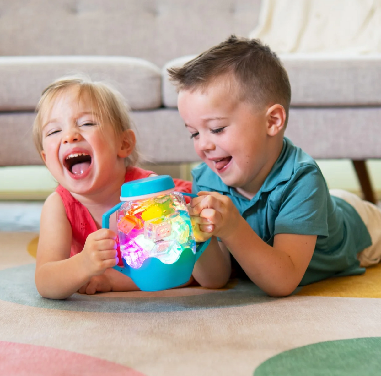 Children playing with the colorful Sensory Jar | Orange, a fun and engaging light-up sensory toy for toddlers.