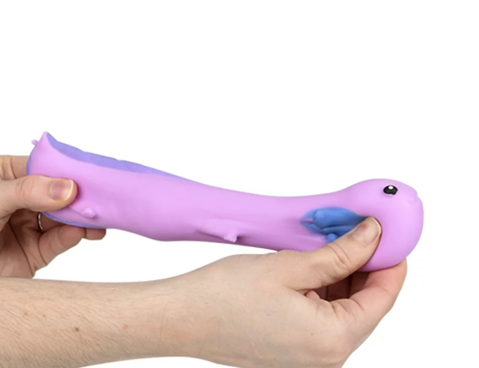 Hands stretching a purple and blue Stretchy Sand Axolotl toy made of smooth silicone and sand-filled inside.