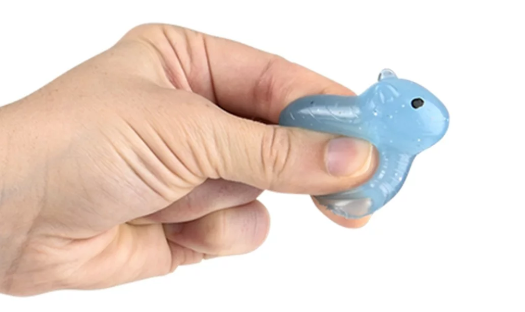 Hand holding a soft, colorful 1.5" Gummy Capybara toy, perfect for collecting and play.