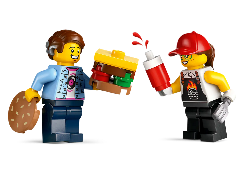 LEGO City Burger Truck minifigures with a giant burger, ketchup bottle, and cookie in a playful food scene.