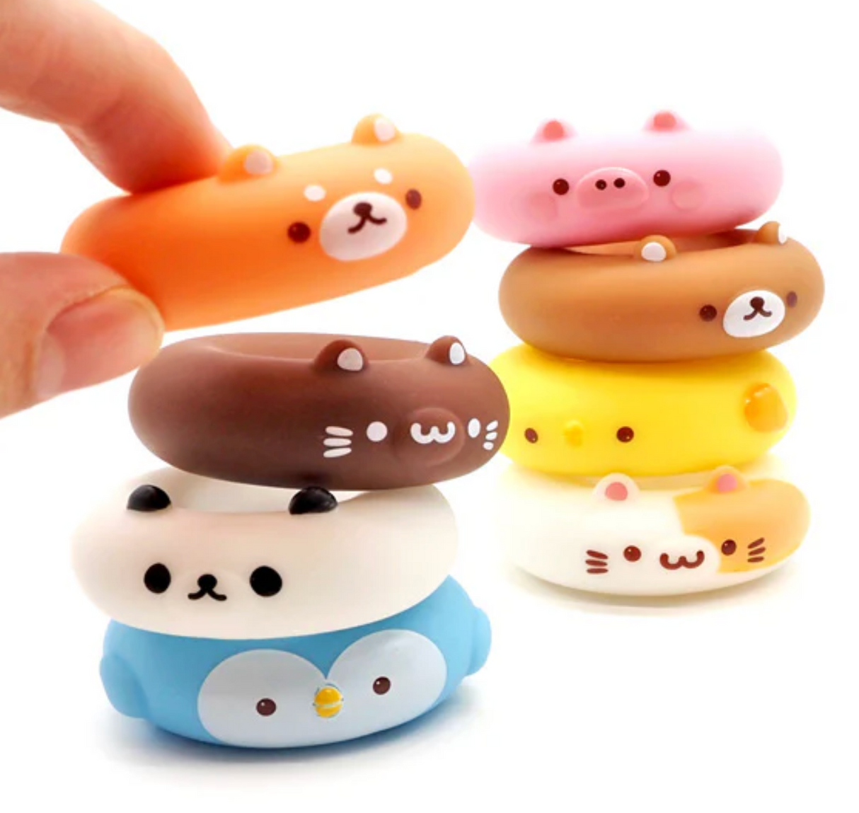 Colorful 2 inch mini animal donuts stacked with a hand holding one, Little Animal Donut from Japan, assorted designs.