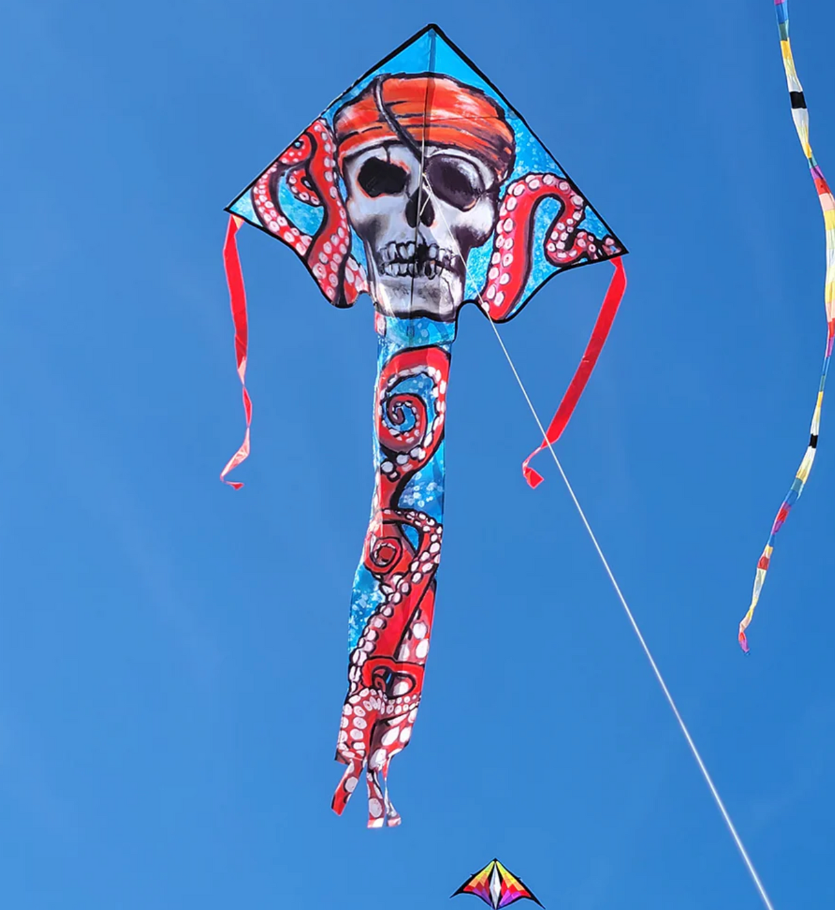 46" Easy Flyer Kite Pirate Octopus with vibrant skull and tentacles design flying against clear blue sky.