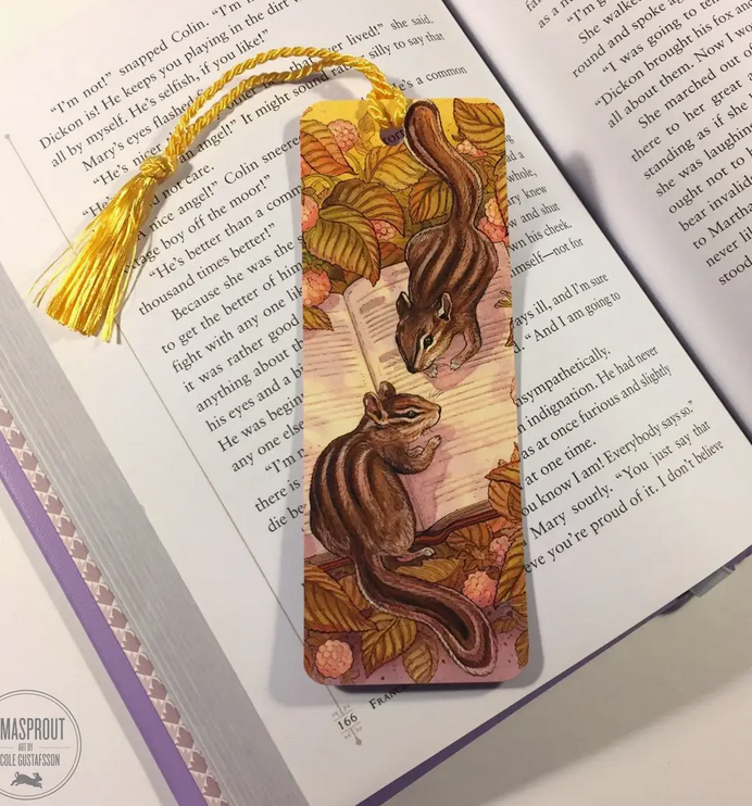 Bookmark | Chipmunk featuring two chipmunks exploring a book beneath autumn leaves with a golden tassel.
