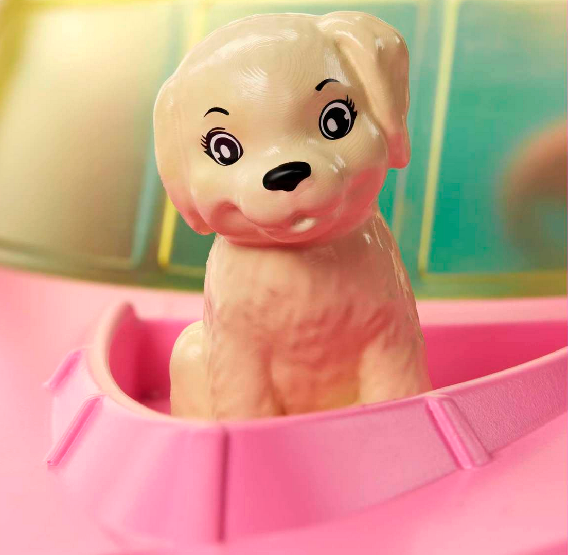 Close-up of Barbie & Boat toy showing a cute puppy figure seated in the pink boat's bow.