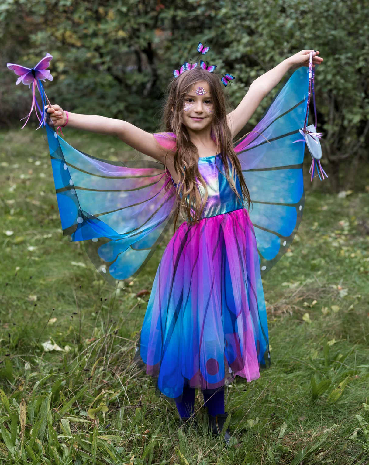 Butterfly Twirl Dress & Wings | Blue Size 5-6 worn by girl with butterfly wings and matching headband outdoors.
