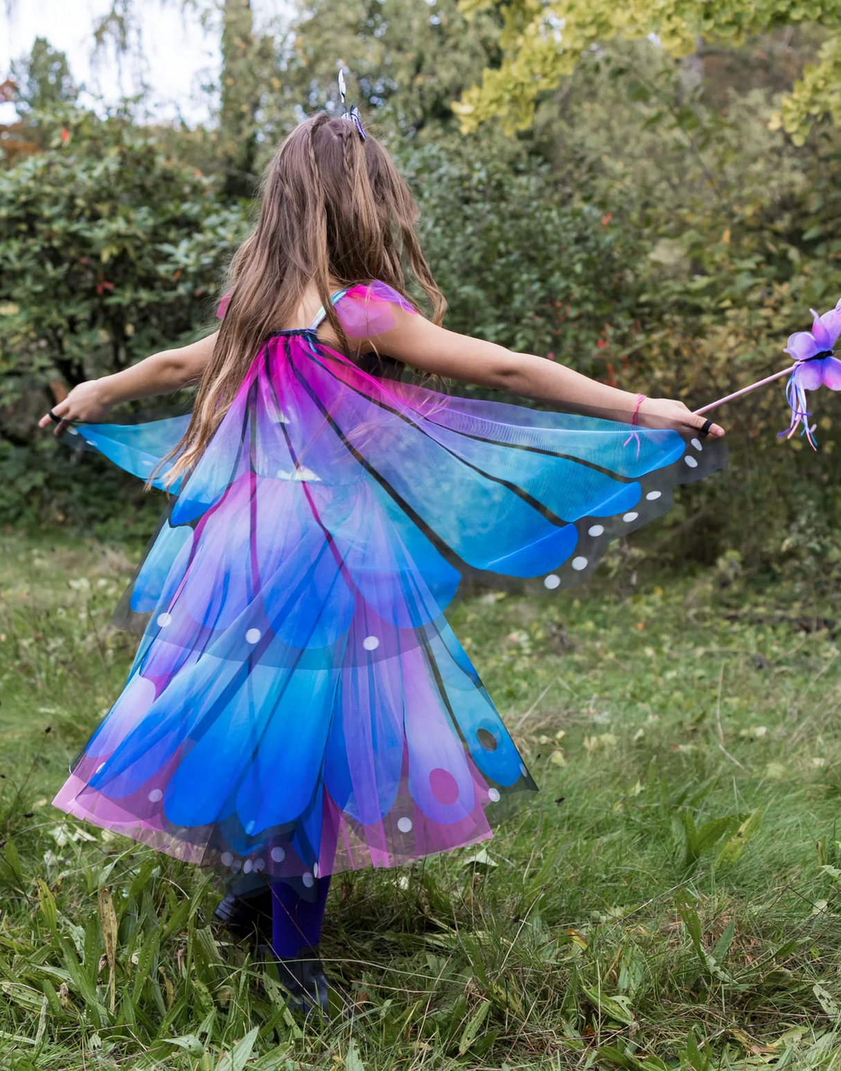 Butterfly Twirl Dress & Wings | Blue Size 3-4 with vibrant blue and purple mesh butterfly wings on a child outdoors