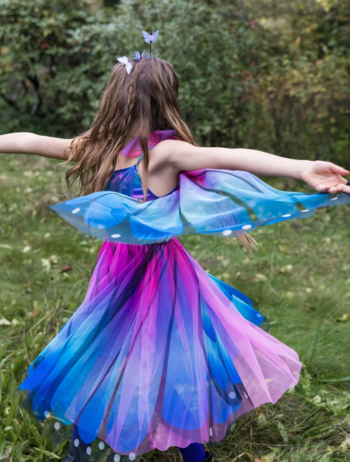 Butterfly Twirl Dress & Wings | Blue Size 3-4 worn by child spinning outdoors with blue and purple butterfly wings.