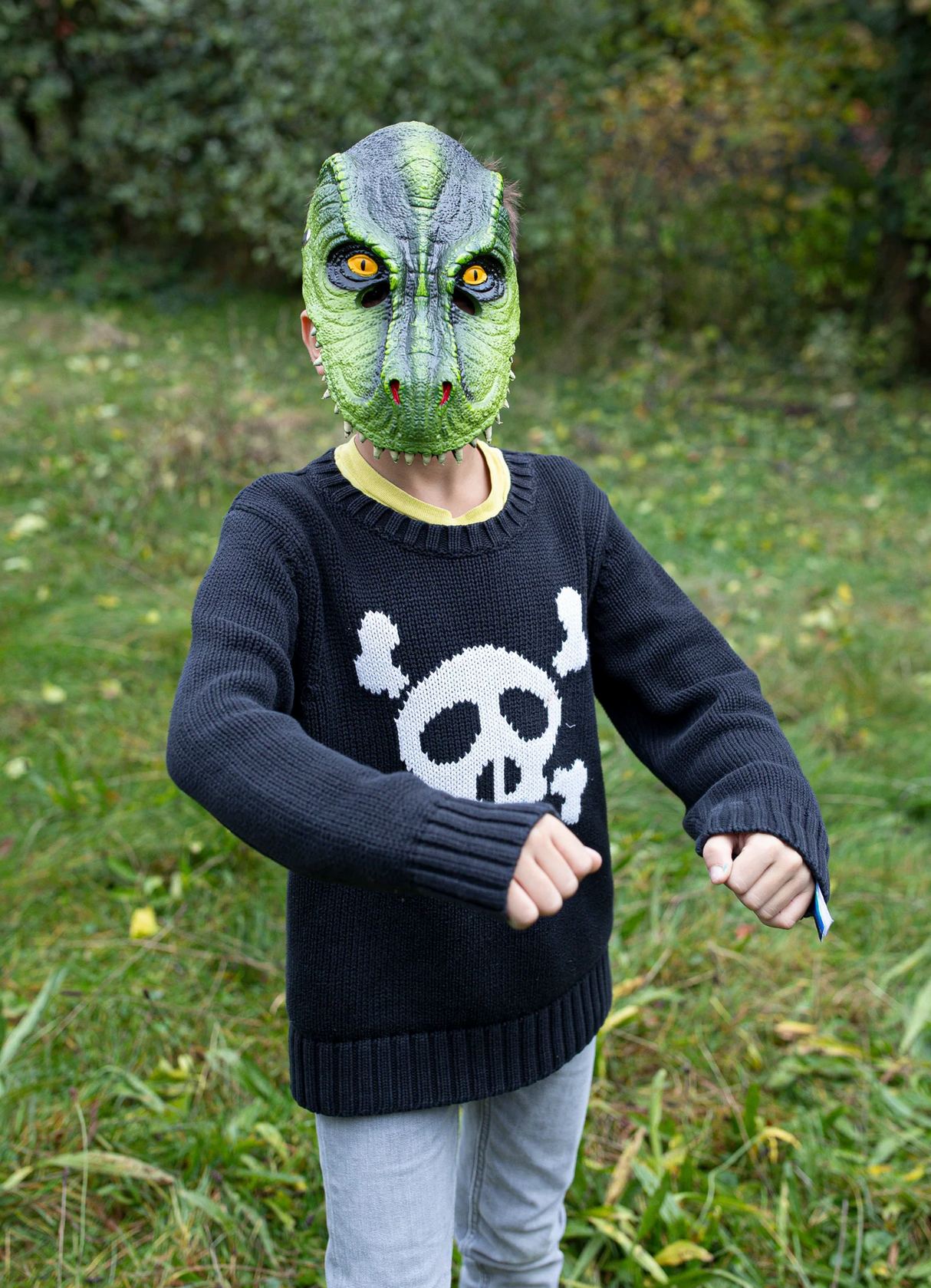Child wearing a vibrant green T-Rex Dino Mask playing outdoors, perfect for imaginative dinosaur role play.