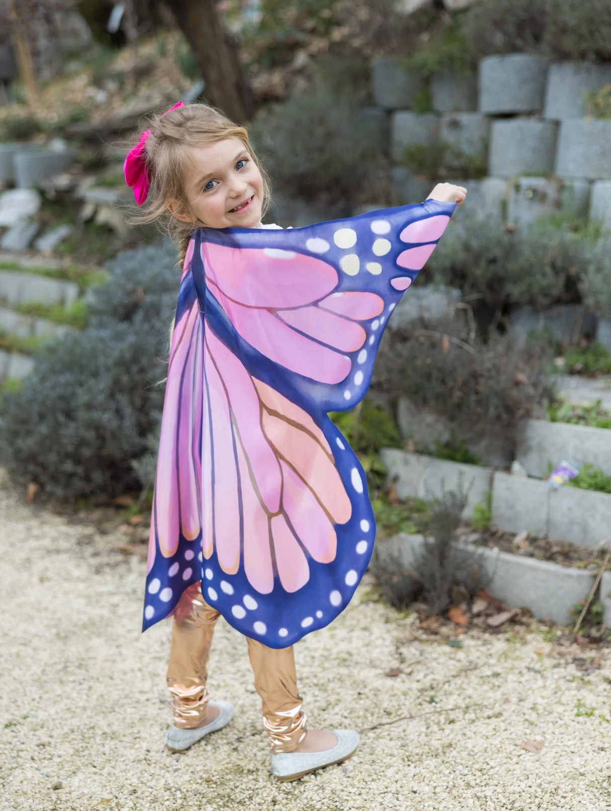 Young girl outdoors wearing Soft Wings | Mystical Monarch with vibrant pink and blue butterfly wing design.