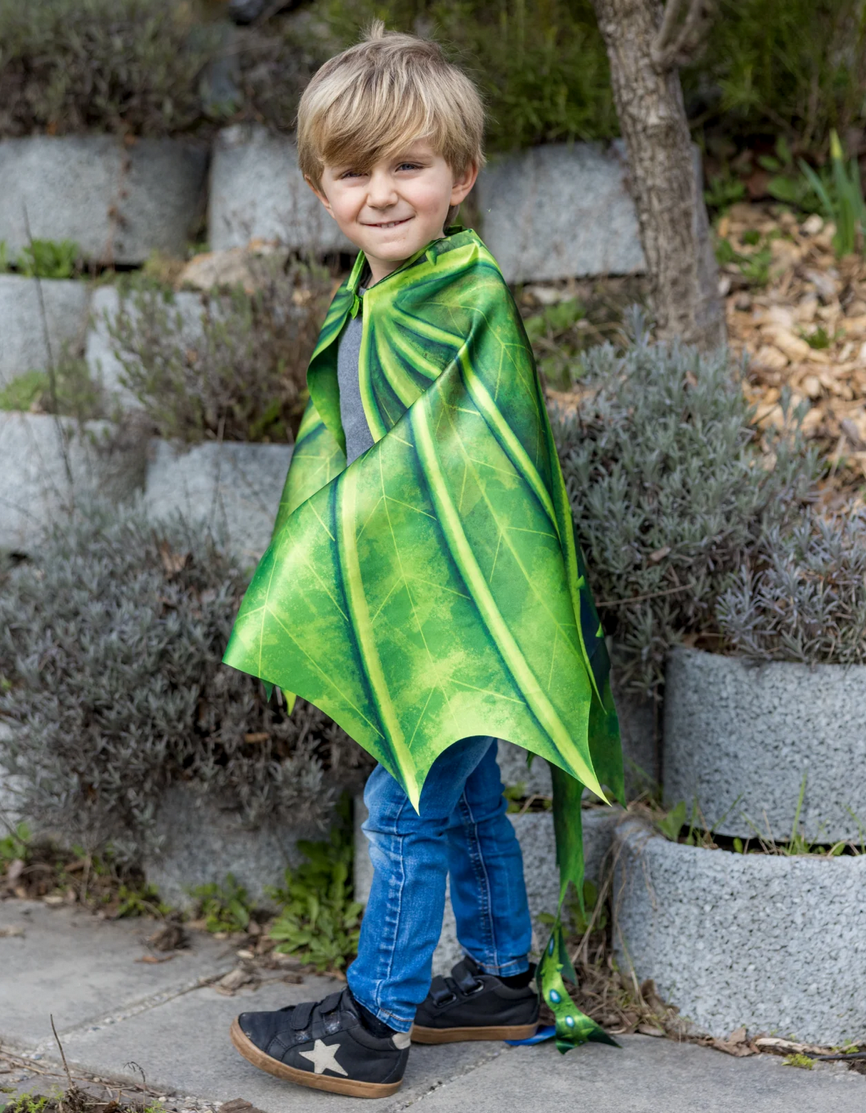 Child wearing the Legendary Dragon Soft Wings and Mask costume, featuring vibrant green dragon wings outdoors.