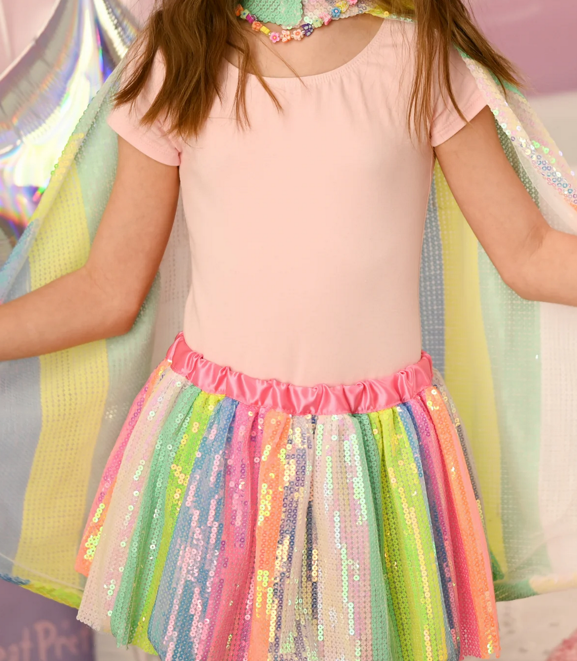 Sequins Skirt | Stripy Size 4-6 with neon rainbow stripes, shiny sequins, and a satin pink waistband on a child.