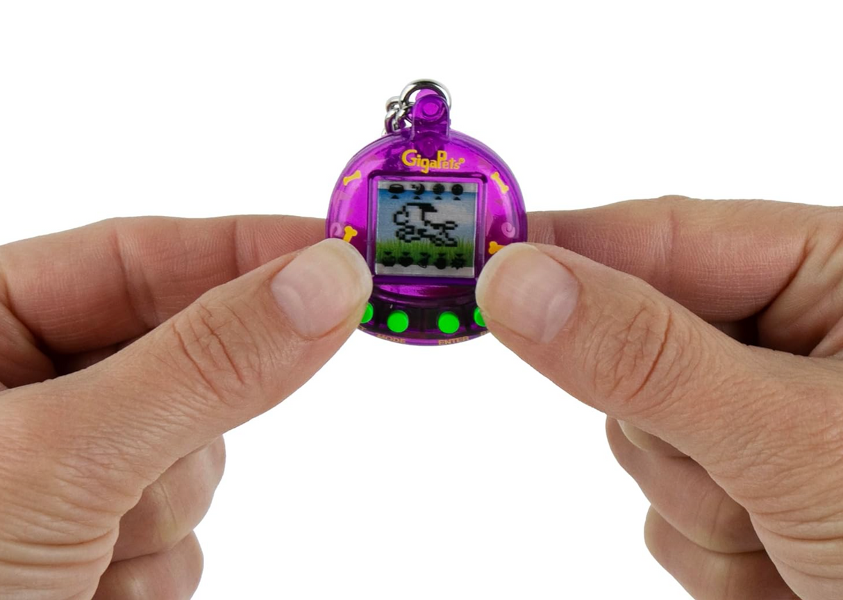 Hands holding the World's Smallest Giga Pet in a purple case with a pixelated pet on screen.