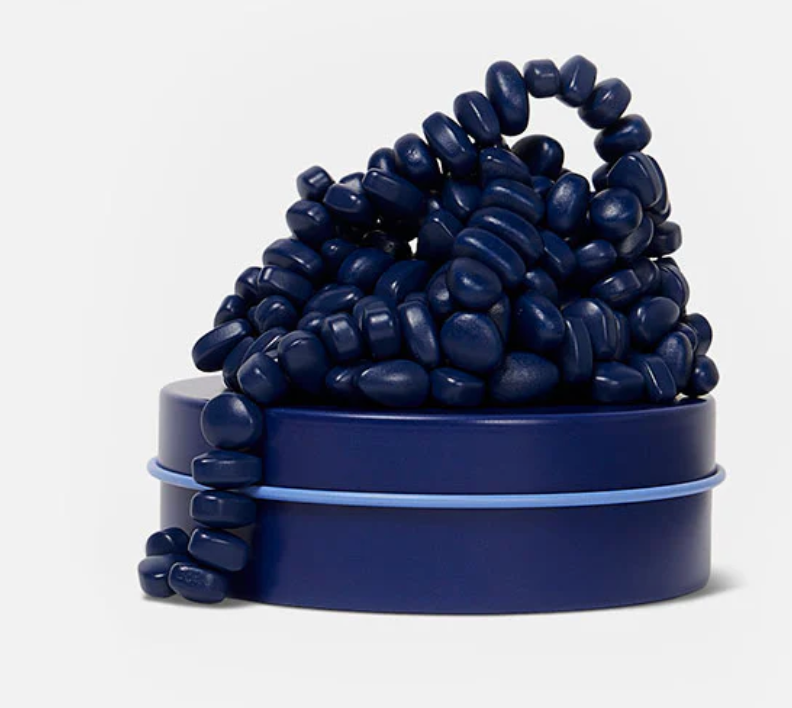 Speks. Matte. Mini Crags. Indigo. showing small, indigo ferrite magnetic putty pieces on a matching tin container.