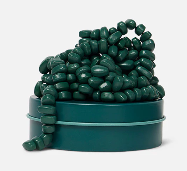 Speks. Matte. Mini Crags. Jade. showing malleable green magnetic putty beads in a small matching tin container.