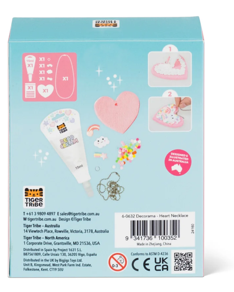 Decorama | Heart Necklace kit showing pink felt heart, white Deco Cream, charms, sprinkles, and silver necklace chain on blue box.