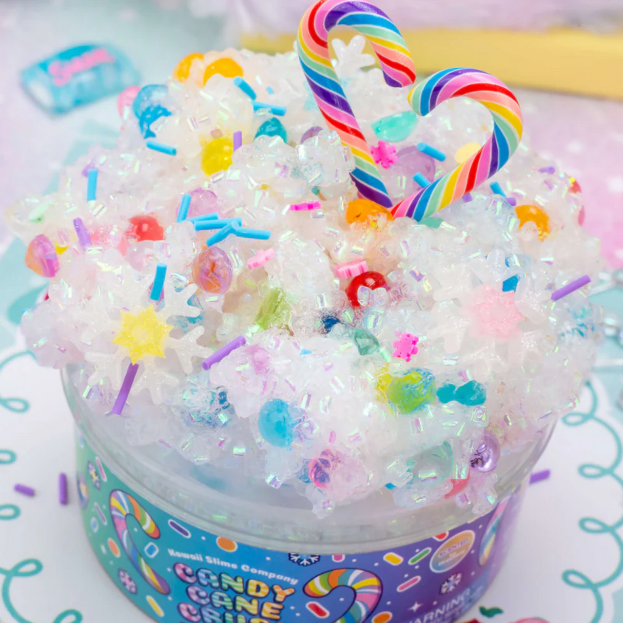 Candy Cane Crush Crunchy Slime with sparkly beads, multicolored sprinkles, and rainbow candy cane decorations.
