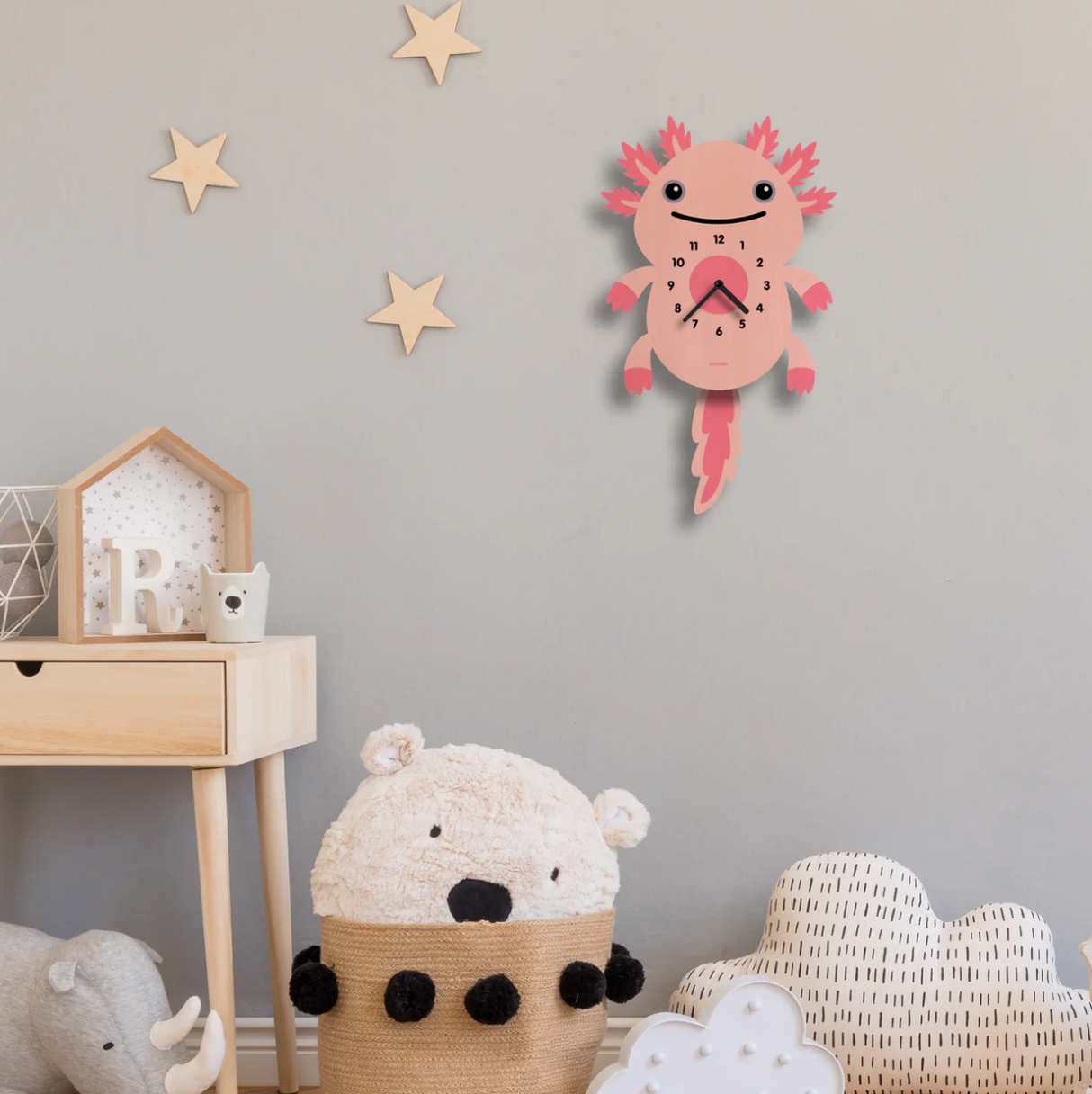 Wood Pendulum Clock | Axolotl hanging in a kids' room with star wall decor and soft toys, natural wood finish.