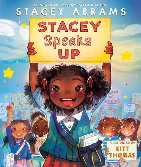 Cover of Stacey Speaks Up showing a smiling girl holding a sign with a crowd behind her at a community rally.