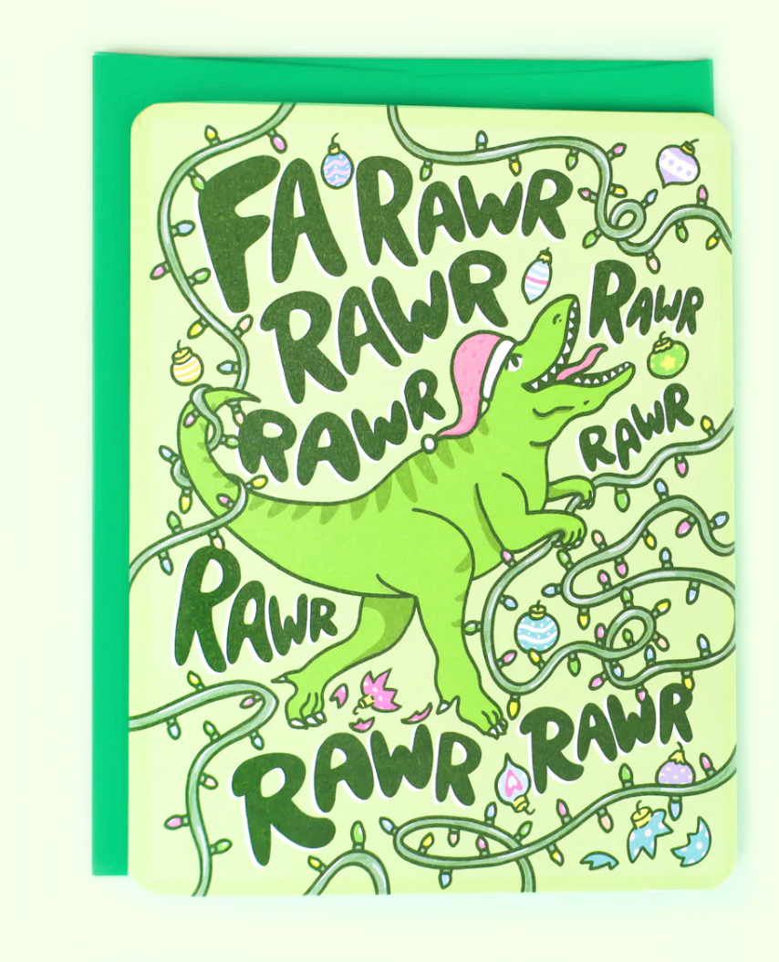 Fa Rawr Dinosaur Christmas Card showing a green dinosaur with Christmas lights and ornaments on a light background.