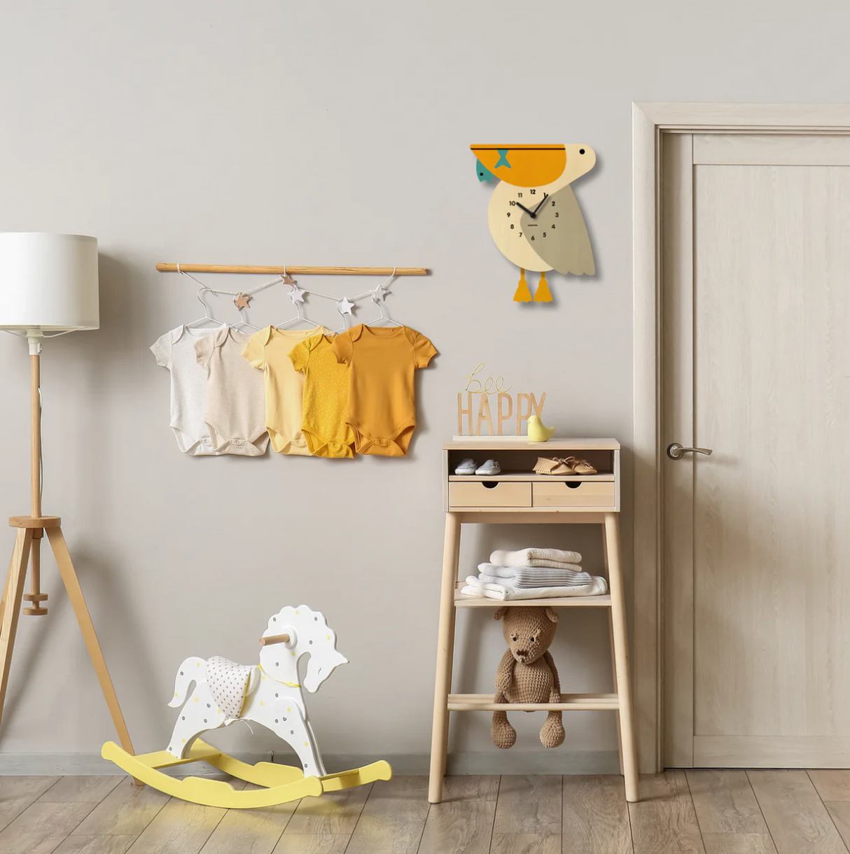 Wood Pendulum Clock | Pelican hanging on wall in a cozy nursery with rocking horse and wooden furniture.