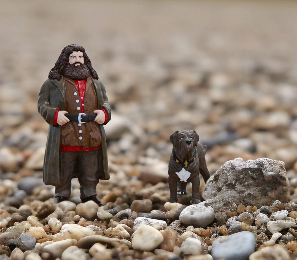 HP Hagrid & Fang figurines standing on rocky ground, featuring Hagrid's gentle spirit and Fang's timid look.