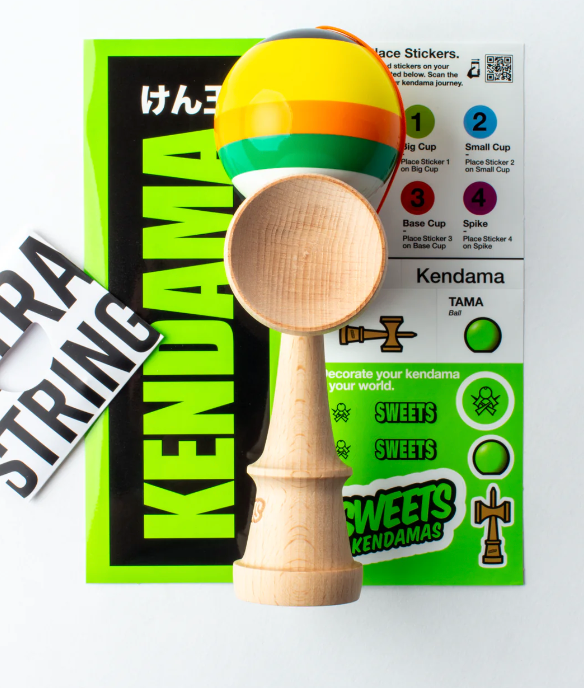 Kendama Prime 5 Stripe | Poncho with colorful striped tama, wooden ken, and included sticker pack for customization.