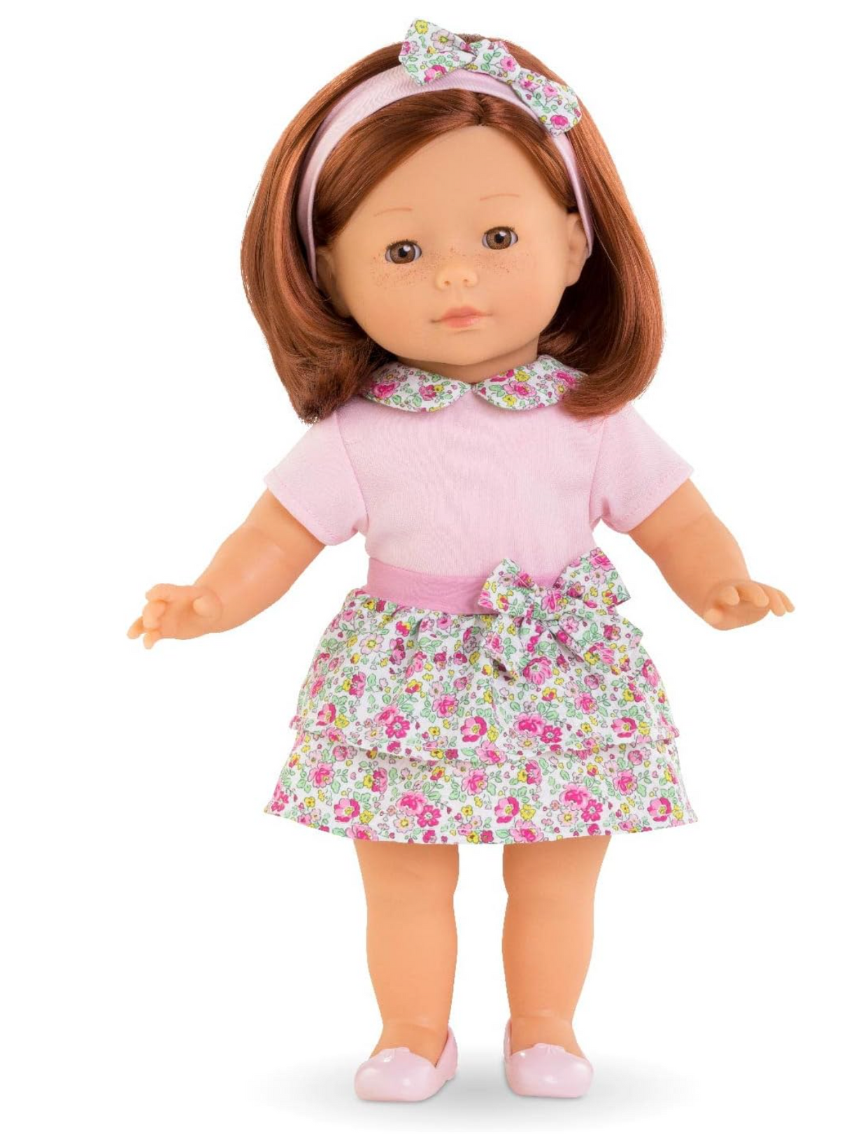 Ma Corolle Pia doll with silky red hair, pink t-shirt, floral skirt, headband, and pink ballet flats.