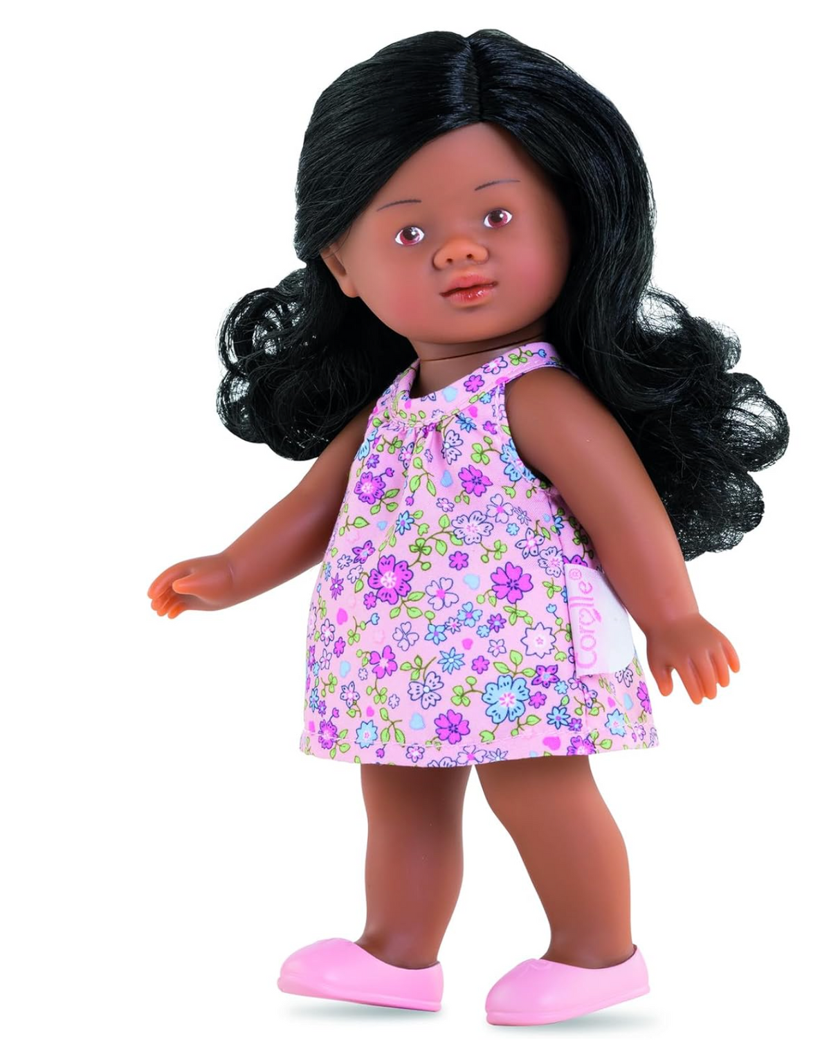 Mini Corolline Rosaly doll with curly dark hair, floral dress, and pink shoes, perfect for children ages 3 and up.