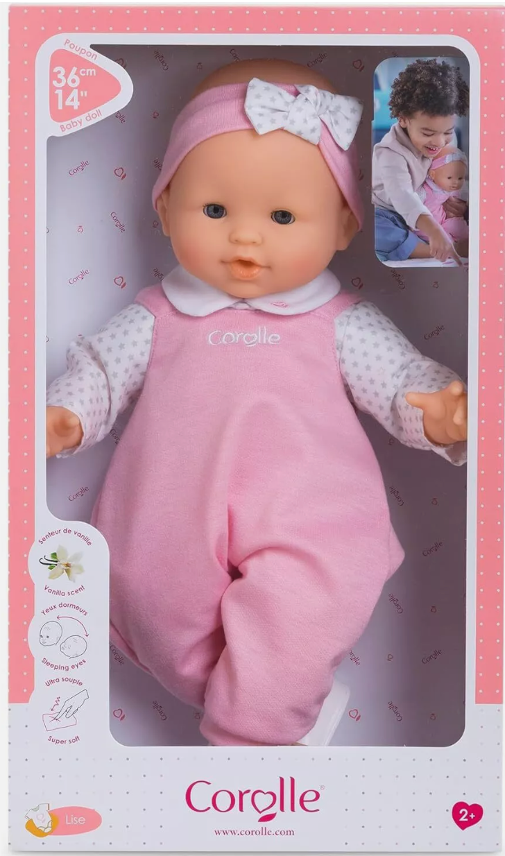 Grand Poupon Lise doll with sleepy blue eyes, soft vinyl skin, vanilla scent, in pink overalls and headband.