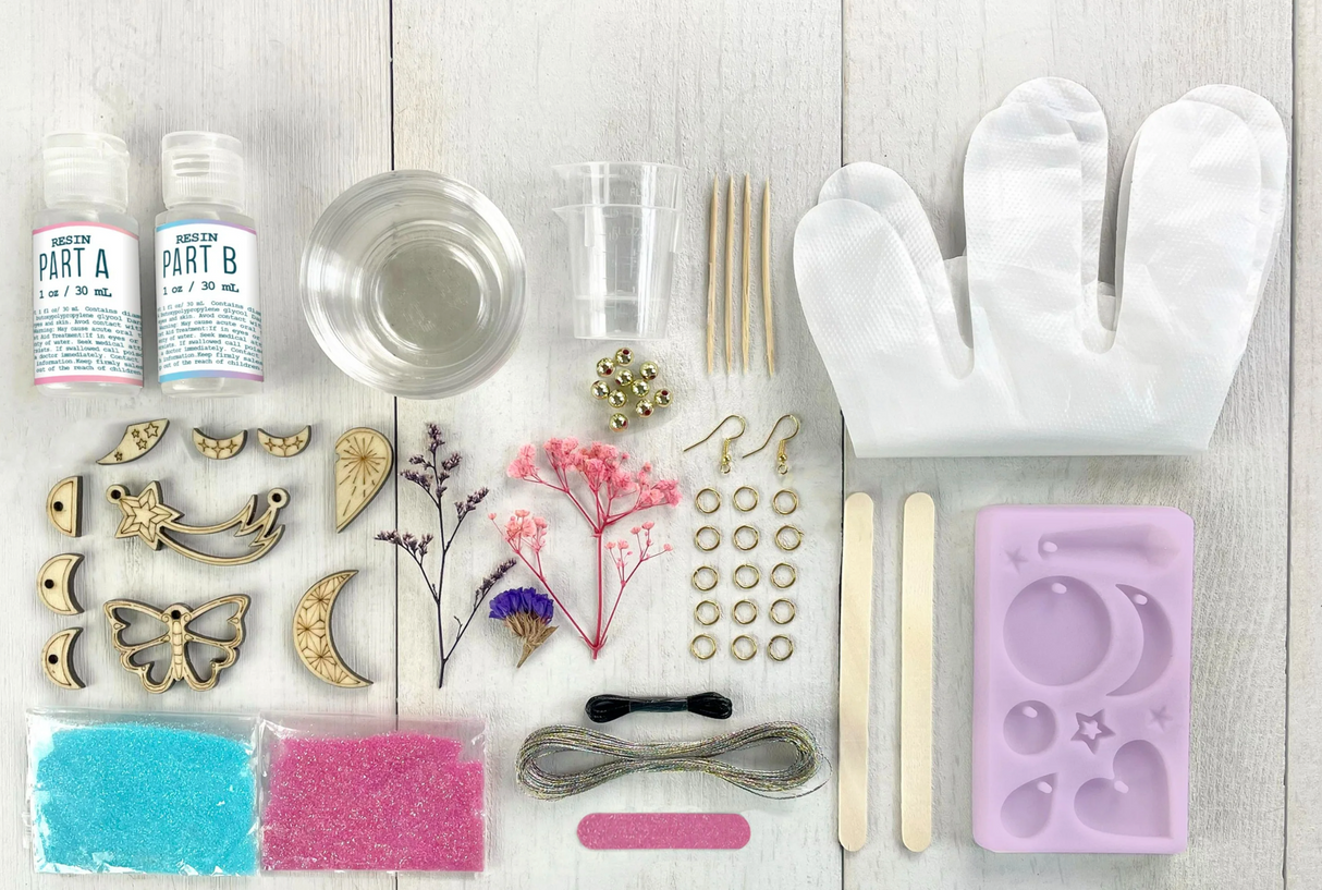 WishCraft Wood & Resin Charm Jewelry kit with resin, dried flowers, laser-cut wood charms, glitter, mold, and jewelry findings.