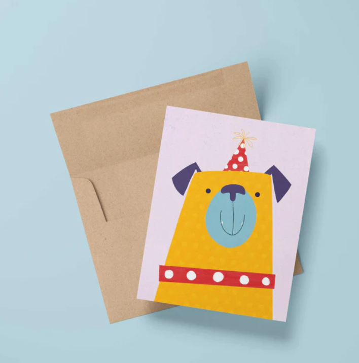Party Pug Birthday Card featuring a cheerful pug in a party hat with kraft envelope on a blue background