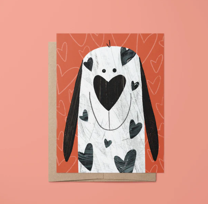 Puppy Love Card featuring a cute dog with heart-shaped spots on an orange background with a kraft paper envelope.