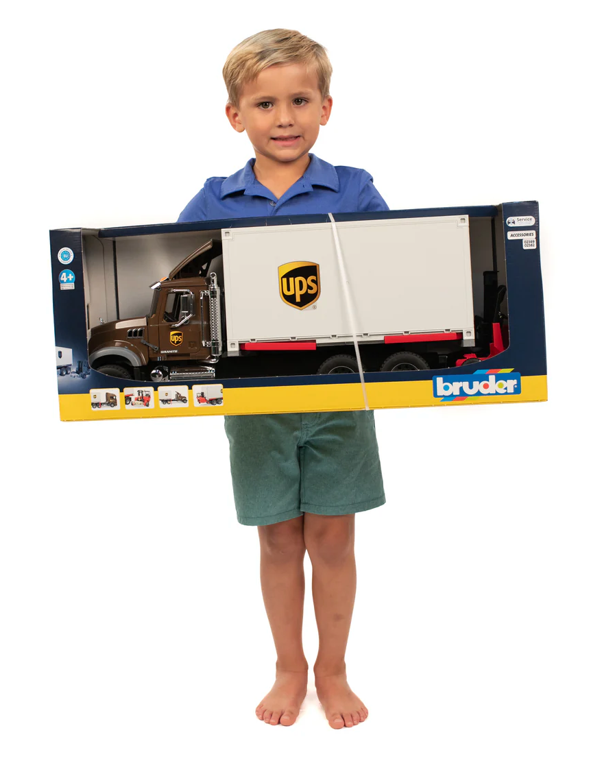 Child holding a boxed MACK Granite UPS Truck with Forklift toy featuring realistic details and UPS branding.