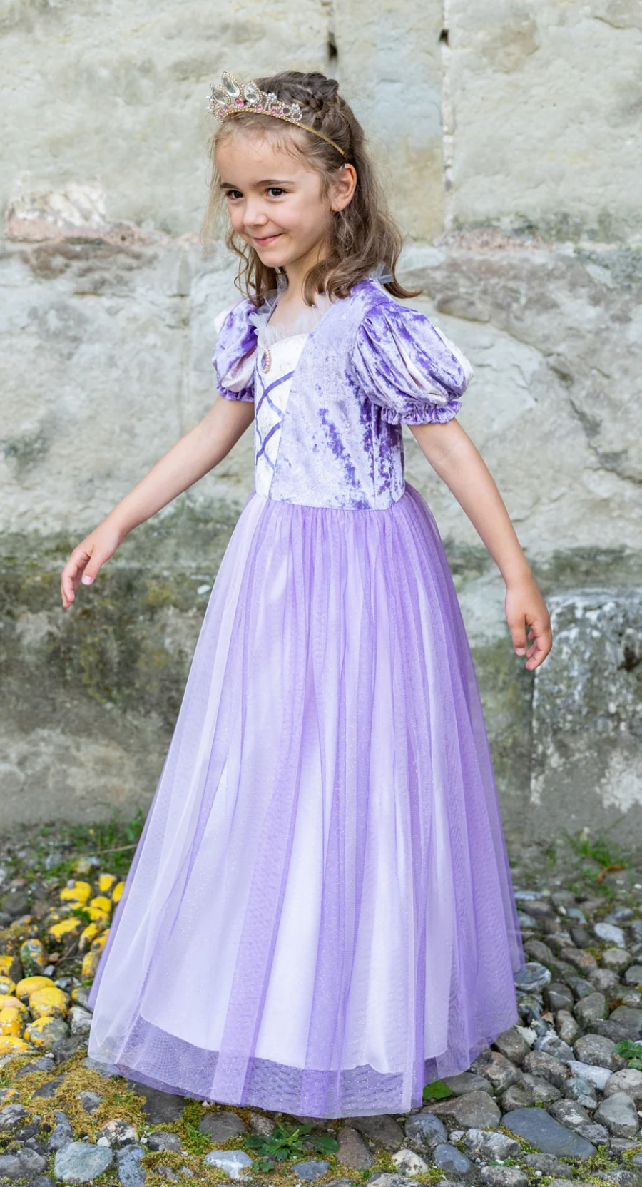 Young girl wearing the Once Upon a Tower Princess Dress in purple velvet with puffed sleeves and full tulle skirt.