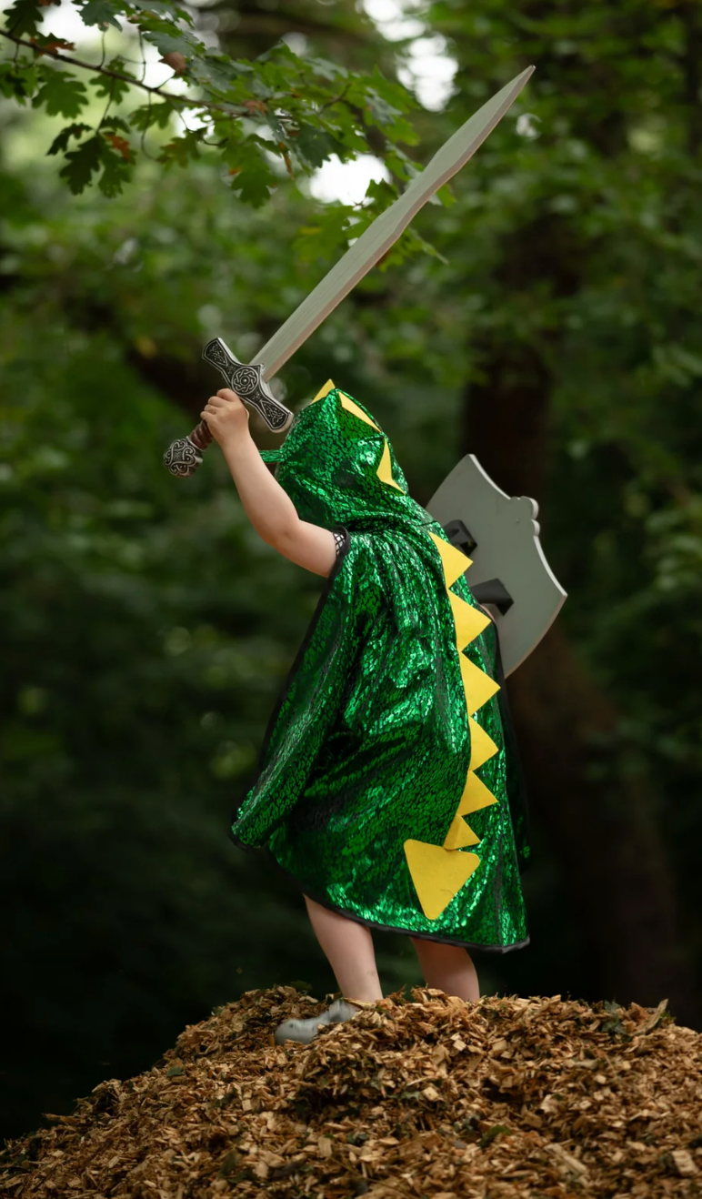 Child in a green costume holding a Viking Sword toy outdoors, ready for imaginative play and dress-up.