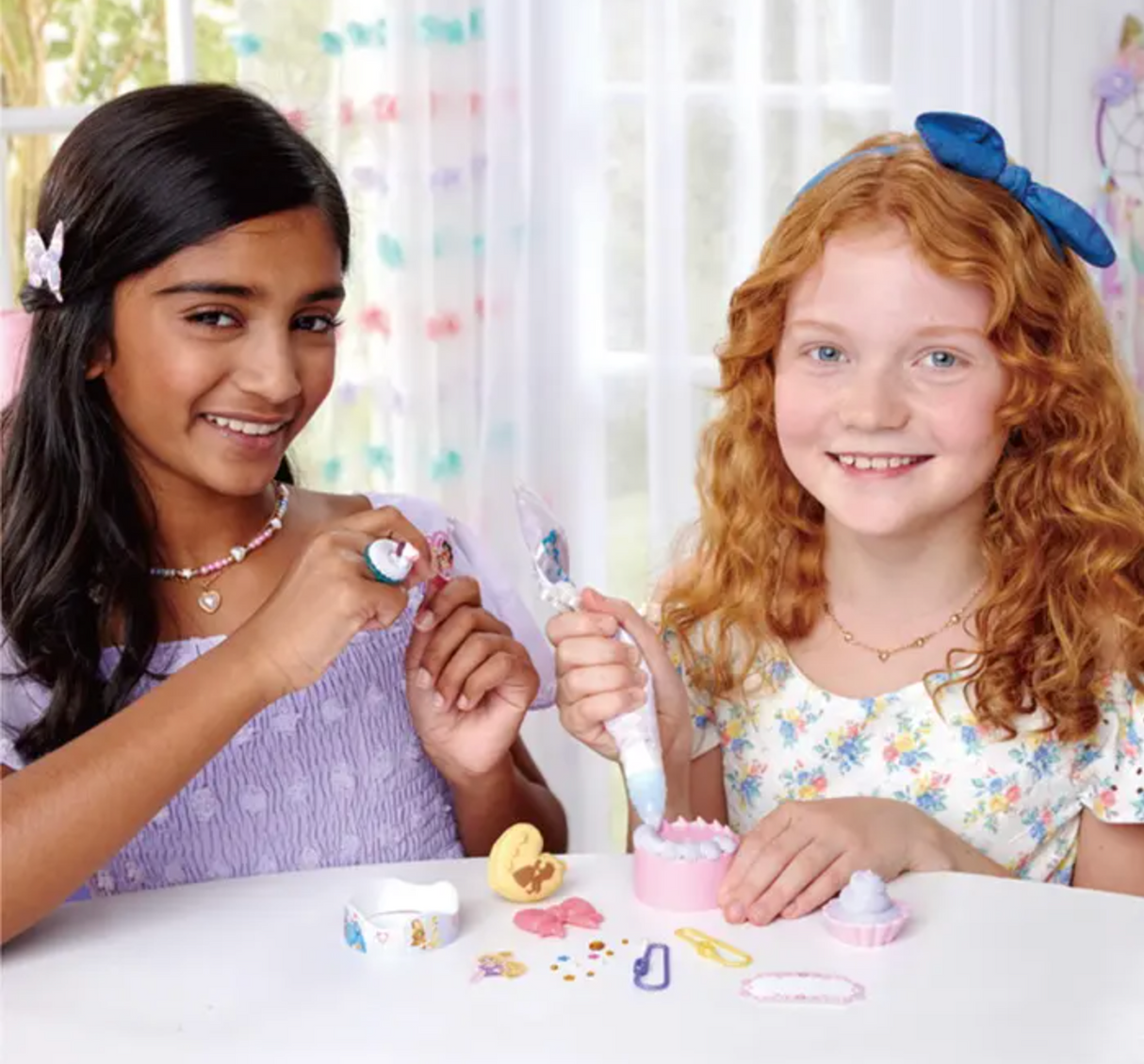 Two girls happily crafting together using the Pati-School Disney Princess Kit with decorations and paste.