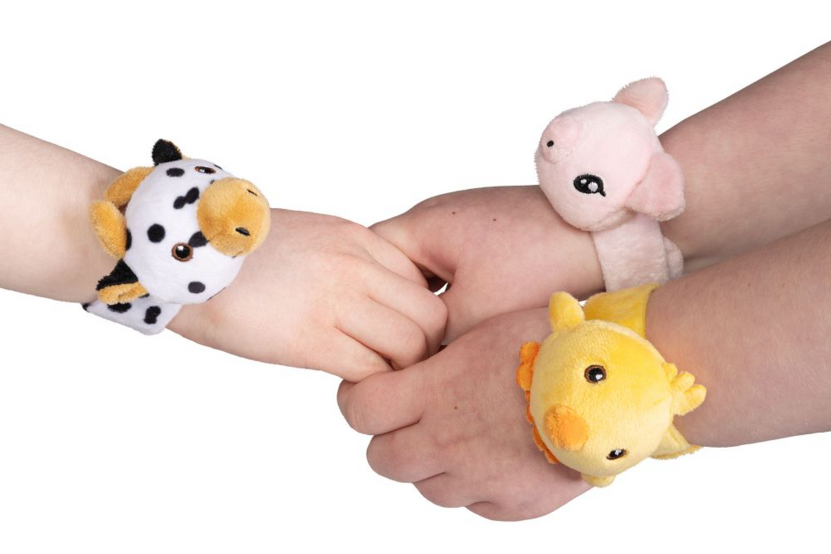Three children's hands wearing Little Band | Farm Face plush slap band bracelets with animal designs on white background.